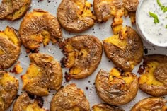 baked potatoes on a baking sheet with ranch dressing