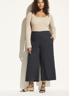 Secured with a jewel-like metal button, our high-waisted pant opens to a sculptural shape before tapering down to a cropped hem. Chic Cropped Leg Bottoms For Business Casual, Chic Cropped Leg Business Casual Bottoms, Modern Cropped Pants For Fall, Chic Cropped Wide Leg Pants For Business Casual, Crop Pants With Ankle Boots, Wide Cropped Pants Outfit, Wide Leg Crop Pants Outfit, Cropped Pants Outfit, Wide Cropped Pants