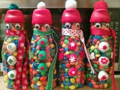 three plastic bottles with candy in them sitting on a counter