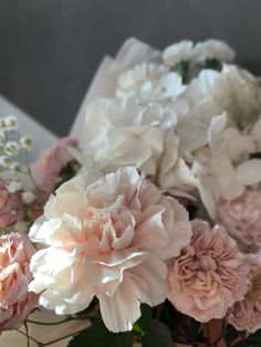 pink and white flowers are in a vase