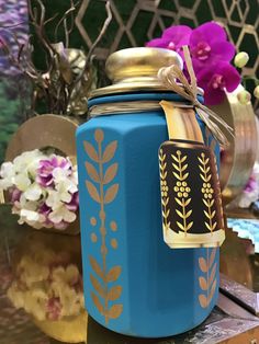 a blue jar sitting on top of a wooden table