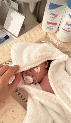 a baby is wrapped up in a towel