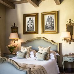 a bedroom with two framed pictures above the bed