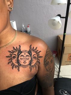 a woman with sun and moon tattoos on her chest