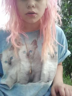 a girl with pink hair wearing a cat t - shirt