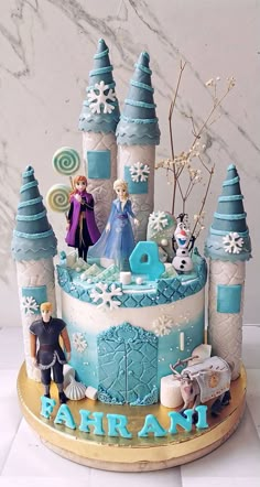 a birthday cake decorated with frozen princess figures