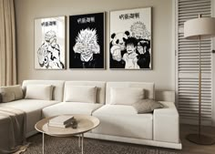 a living room filled with white furniture and paintings on the wall above it's couch