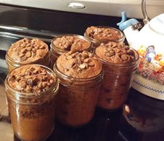 several jars filled with cookies sitting on top of a stove