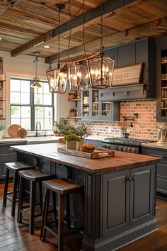 a kitchen with an island and lots of lights hanging from it's ceiling beams