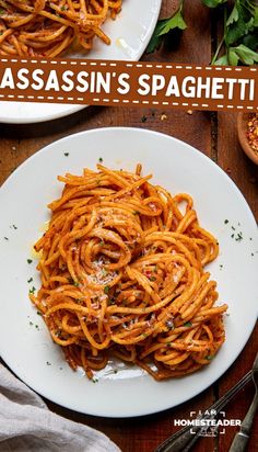 two plates of pasta with sauce and parsley on the side