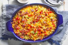 a casserole dish with sausage, cheese and vegetables in it on a table