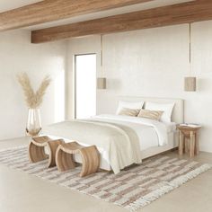 a large white bed sitting in a bedroom next to a tall wooden headboard and foot board