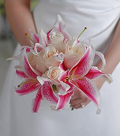 a bride holding a bouquet of flowers in her hands