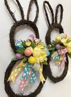 two wreaths made to look like bunnies with flowers on them