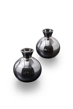 two black glass vases sitting next to each other