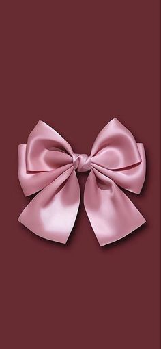 a pink bow on a red background