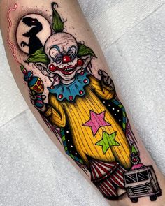 a clown tattoo on the leg of a person