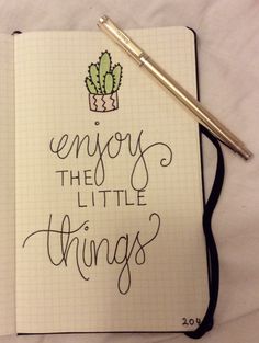 an open notebook with the words enjoy the little things written in cursive writing