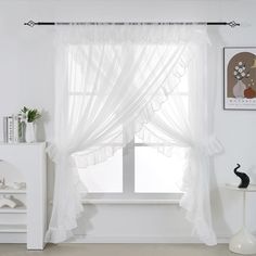 a white room with a window and curtains