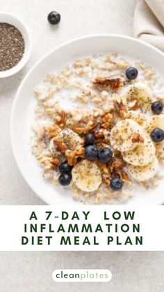 a bowl of oatmeal with blueberries, bananas and granola on top