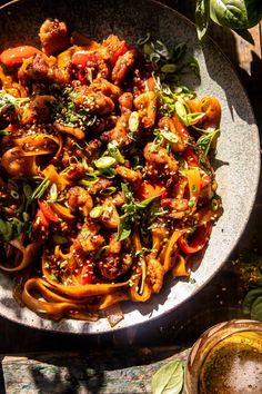 a plate full of pasta with meat and vegetables