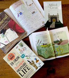 four children's books sitting on top of a wooden table next to each other