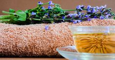 a cup of tea sitting on top of a table next to a pile of towels