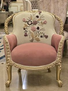 an ornate chair with pink velvet upholstered on the back