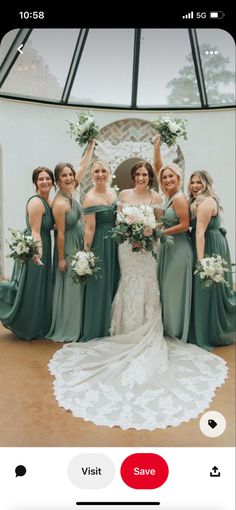 a group of women standing next to each other in front of a mirror holding bouquets