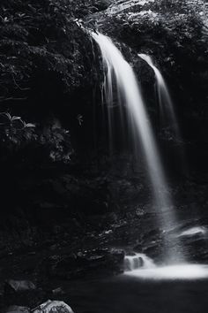 a black and white photo of a waterfall