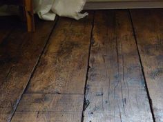 an old wooden floor with white furnishing on the top and bottom part of it