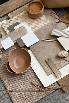 a table topped with lots of different items on top of a rug next to a bowl