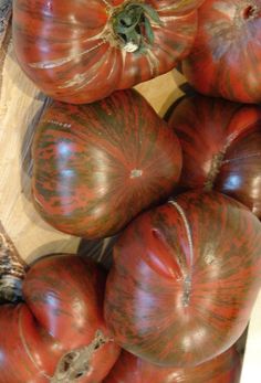 several tomatoes are stacked on top of each other