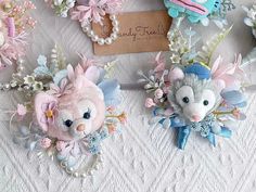 several small stuffed animals are on display with flowers and pearls around them, along with a card that says happy easter