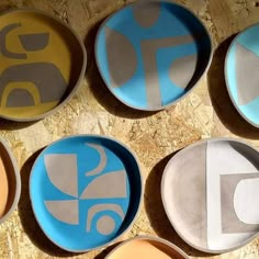 six plates with different designs on them sitting on a table