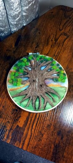 a plate with a tree on it sitting on top of a wooden table