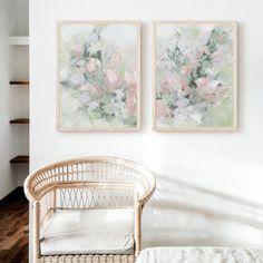 two paintings hang on the wall above a wicker chair