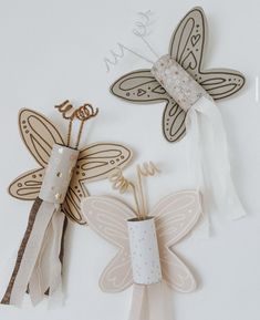 three different types of paper butterflies on a white surface