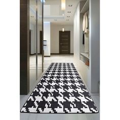 a black and white rug is on the floor next to an open closet with glass doors