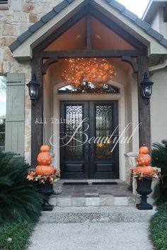 an entrance to a home decorated for halloween with pumpkins on the front and side