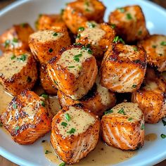 a white plate topped with potatoes covered in gravy and garnished with parsley