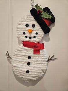 a snowman ornament hanging on a door