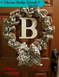 a monogrammed wreath with the letter b on it and two bows hanging from the front door