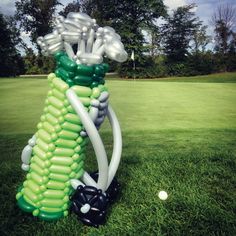 an inflatable golf ball and tee on the grass