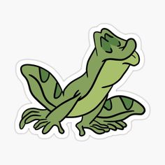 a green lizard sticker sitting on top of a white surface with an outline of it's body