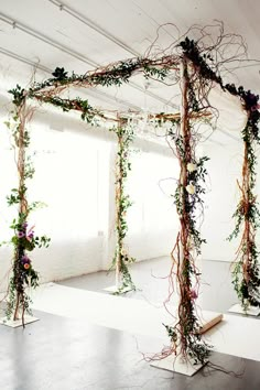 an arrangement of vines and flowers is arranged on the floor