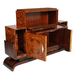 an art deco cabinet with two doors and drawers