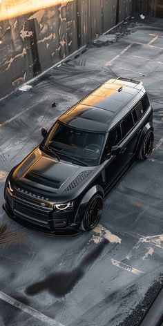 a black suv parked in an empty parking lot