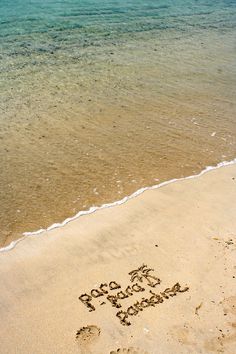 the word hope written in the sand next to the water on a beach with waves coming in