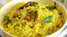 a bowl filled with yellow rice and vegetables